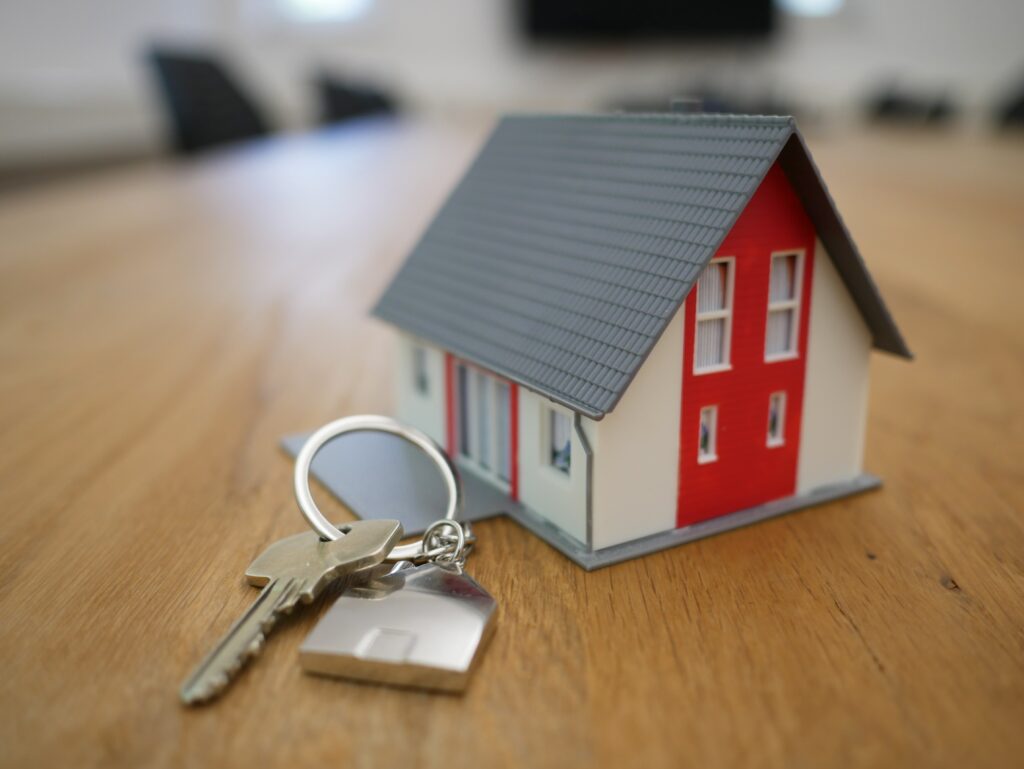 Small toy home with keys next to it.